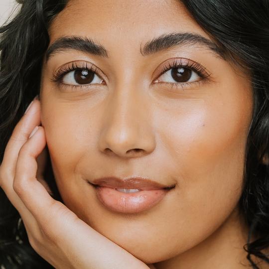 model wearing Elate Cosmetics Better Balm in Clarity - Made in Canada, cruelty-free., plastic-free 